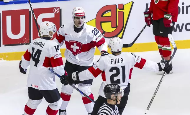 Switzerland's forward Timo Meier, center, celebrates his goal with his teammates Dean Kukan, left and Kevin Fiala, center right after scoring, during the IIHF 2025 World Championship preliminary round group B game between Hungary and Switzerland, at the Jyske Bank Boxen, in Herning, Denmark, Sunday, May 18, 2025. (Salvatore Di Nolfi/Keystone via AP)
