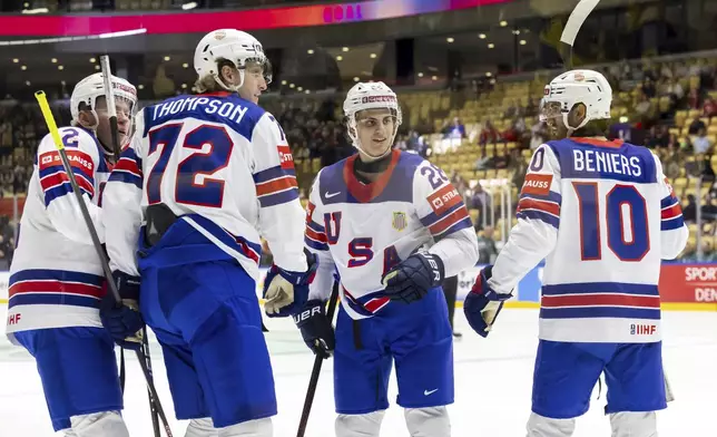 USA's Tage Thompson, 2nd left, celebrates his goal with teammates, Jackson Lacombe, left, Zeev Buium, 2nd right, and Matty Beniers, right, during the IIHF 2025 World Championship preliminary round group B game between Kazakhstan and USA, at the Jyske Bank Boxen, in Herning, Denmark, Sunday, May 18, 2025. (Salvatore Di Nolfi/Keystone via AP)