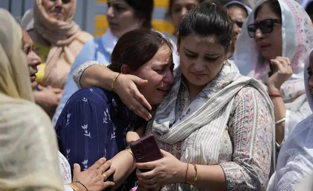 Relatives mourn at the funeral of Raj Thapa, a senior bureaucrat who was killed in Pakistani shelling in Rajouri, in Jammu, India, Sunday, May 11, 2025. (AP Photo/Channi Anand)