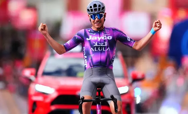 Australian rider Luke Plapp celebrates as he cycles to the finish line to win during the stage 8 of the Giro d'Italia from Giulianova to Castelraimondo, Italy, Saturday, May 17, 2025. (Massimo Paolone/LaPresse via AP)