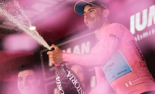 Ulissi Diego celebrates wearing the pink jersey of the overall leader following Stage 8 of the Giro d'Italia from Giulianova to Castelraimondo, Italy, Saturday, May 17, 2025. (Marco Alpozzi/LaPresse via AP)