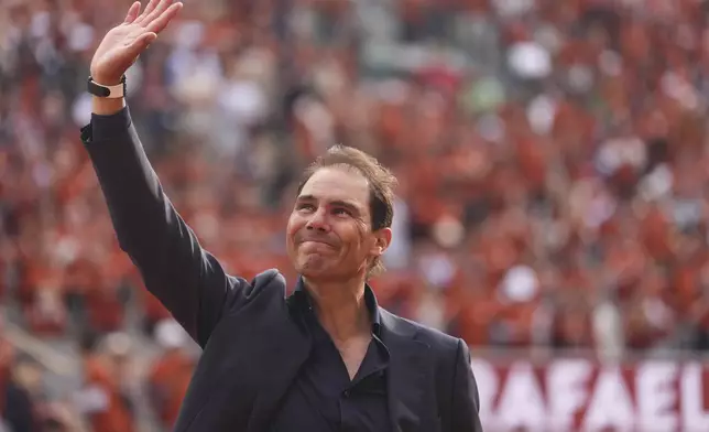Rafa Nadal waves to the crowd during a farewell ceremony at center court Philippe-Chatrier, at the Roland-Garros stadium, in Paris, Sunday May 25, 2025. (AP Photo/Lindsey Wasson)