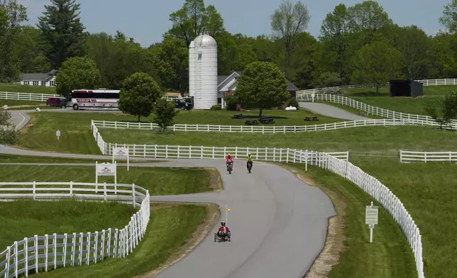 Cyclists take advantage of fine spring weather to ride a road between pastures at Pineland Farms, Wednesday, May 28, 2025, in New Gloucester, Maine. (AP Photo/Robert F. Bukaty)