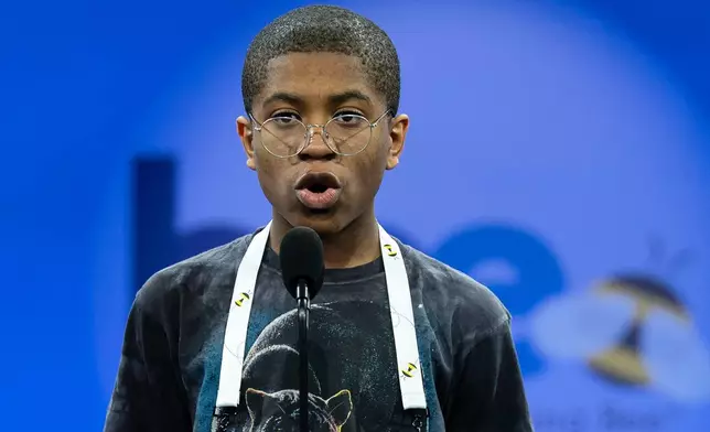 Zwe Sunyata Spacetime, 13, of Washington, spells his word as he competes during the first preliminary round of the Scripps National Spelling Bee at the Gaylord National Resort &amp; Convention Center, Tuesday, May 27, 2025, in Oxon Hill, Md. (AP Photo/Jose Luis Magana)