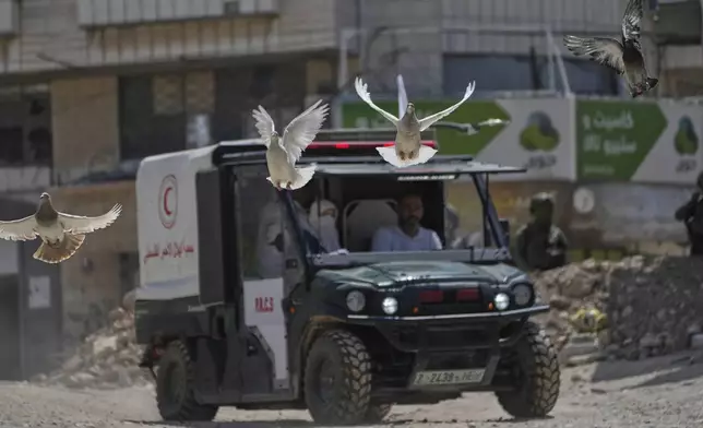 A Palestinian Red Crescent vehicle evacuates residents of the now evacuated refugee camp of Tulkarem who returned to collect belongings before the destruction of their homes as Israeli forces prepared to carry out the demolition of homes across the two refugee camps of the Israeli occupied West Bank city of Tulkarem, Thursday, May 29, 2025. (AP Photo/Nasser Nasser)