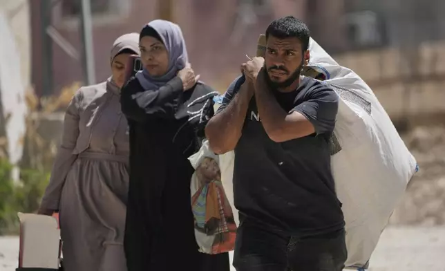 Residents of the now evacuated Palestinian refugee camp of Tulkarem return to collect belongings before the destruction of their homes as Israeli forces prepared to carry out the demolition of homes across the two refugee camps of the Israeli occupied West Bank city of Tulkarem, Thursday, May 29, 2025. (AP Photo/Nasser Nasser)