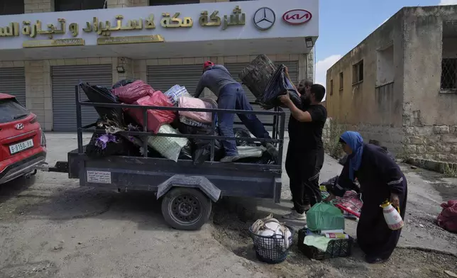 Residents of the now evacuated Palestinian refugee camp of Tulkarem who return to collect belongings before the destruction of their homes as Israeli forces prepared to carry out the demolition of homes across the two refugee camps of the Israeli occupied West Bank city of Tulkarem, Thursday, May 29, 2025. (AP Photo/Nasser Nasser)