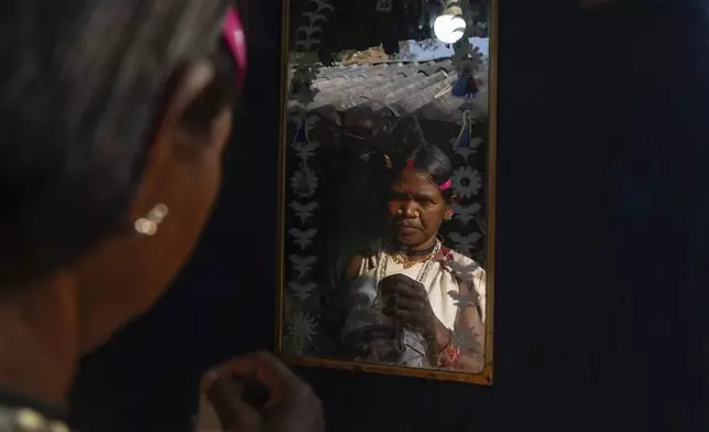 A woman, from the Durua Indigenous community, prepares to take part in the Chaitra Parab festival, a monthlong harvest celebration, in Hatipakna village, Koraput district, in India's eastern state of Odisha, Thursday, April 17, 2025. (AP Photo/Rafiq Maqbool)