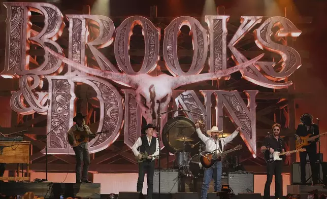Cody Johnson, center, and Brooks &amp; Dunn perform "Red Dirt Road" during the 60th annual Academy of Country Music Awards on Thursday, May 8, 2025, in Frisco, Texas. (AP Photo/Chris Pizzello)