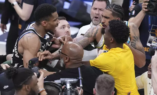 Milwaukee Bucks forward Giannis Antetokounmpo, left, is separated from Indiana Pacers players forward Obi Toppin, second from right, and guard Bennedict Mathurin, right, after Game 5 of an NBA basketball first-round playoff series in Indianapolis, Tuesday, April 29, 2025. (AP Photo/Michael Conroy)
