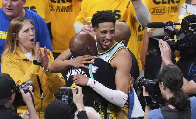 Indiana Pacers guard Tyrese Haliburton (0) hugs his father John Haliburton following Game 5 of an NBA basketball first-round playoff series against the Milwaukee Bucks, Tuesday, April 29, 2025, in Indianapolis. (AP Photo/Michael Conroy)
