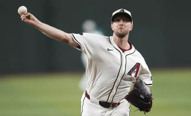 Arizona Diamondbacks starting pitcher Merrill Kelly warms up prior to a baseball game against the Colorado Rockies Sunday, May 18, 2025, in Phoenix. (AP Photo/Ross D. Franklin)