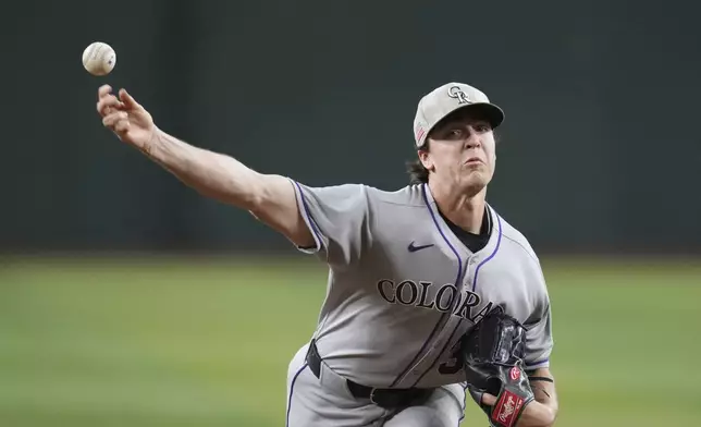 Colorado Rockies starting pitcher Chase Dollander warms up during the first inning of a baseball game against the Arizona Diamondbacks Sunday, May 18, 2025, in Phoenix. (AP Photo/Ross D. Franklin)