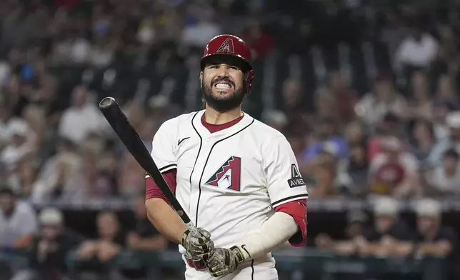 Arizona Diamondbacks' Eugenio Suárez reacts to striking out against the Colorado Rockies during the first inning of a baseball game Sunday, May 18, 2025, in Phoenix. (AP Photo/Ross D. Franklin)
