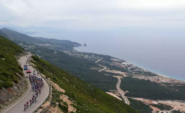 The pack rides during the third stage of the Giro d'Italia cycling race, from Vlore to Vlore, Albania, Sunday, May 11, 2025. (Fabio Ferrari/LaPresse via AP)