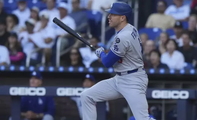 Los Angeles Dodgers' Freddie Freeman (5) hits a single to center field during the first inning of a baseball game against the Miami Marlins, Wednesday, May 7, 2025, in Miami. (AP Photo/Marta Lavandier)