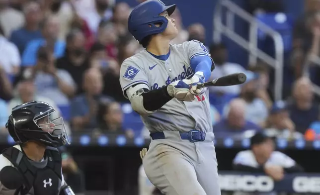 Los Angeles Dodgers' Shohei Ohtani (17) hits a triple to right field during the sixth inning of a baseball game against the Miami Marlins, Wednesday, May 7, 2025, in Miami. (AP Photo/Marta Lavandier)