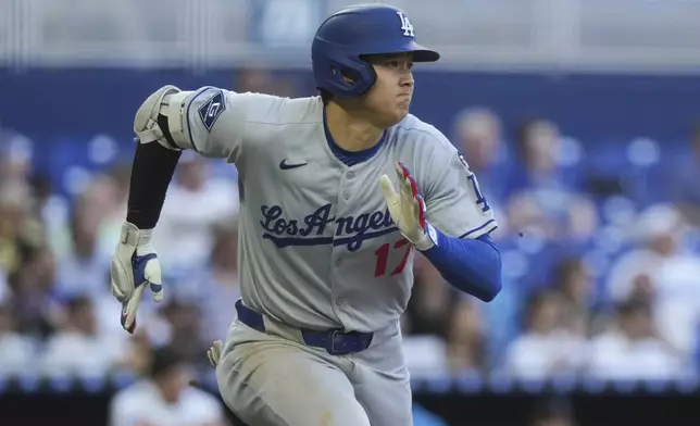 Los Angeles Dodgers' Shohei Ohtani (17) runs after hitting a triple during the sixth inning of a baseball game against the Miami Marlins, Wednesday, May 7, 2025, in Miami. (AP Photo/Marta Lavandier)
