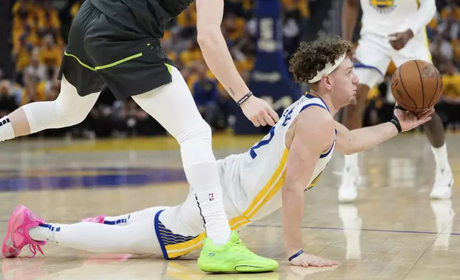Golden State Warriors guard Brandin Podziemski passes the ball during the first half of Game 3 of an NBA basketball second-round playoff series against the Minnesota Timberwolves, Saturday, May 10, 2025, in San Francisco. (AP Photo/Godofredo A. Vásquez)