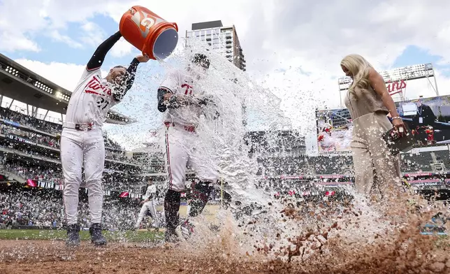 Minnesota Twins' Brooks Lee is doused with water by Ryan Jeffers after his walk off single against the Kansas City Royals during the ninth inning of baseball game, Saturday, May 24, 2025, in Minneapolis. (AP Photo/Matt Krohn)