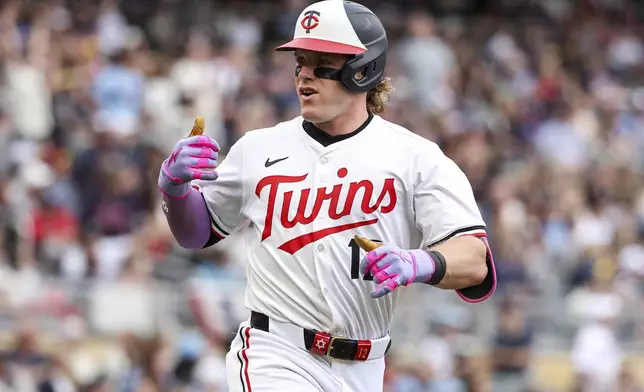 Minnesota Twins' Harrison Bader celebrates his solo home run as he runs the bases during the fifth inning of baseball game against the Kansas City Royals Saturday, May 24, 2025, in Minneapolis. (AP Photo/Matt Krohn)