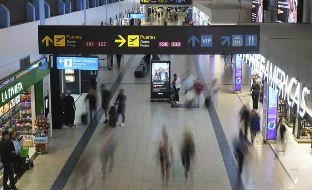 Travelers walk through Tocumen International Airport in Panama City, Thursday, May 22, 2025, as Panama and Venezuela prepare to resume commercial flights nearly a year after suspending them when Panamanian President Jose Raul Mulino refused to recognize the re-election of Venezuelan President Nicolas Maduro. (AP Photo/Matias Delacroix)
