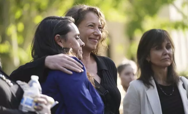 Supporters and family of Erik and Lyle Menendez, including cousin Anamaria Baralt, center, embrace after the brothers' resentencing hearing Tuesday, May 13, 2025, in Los Angeles. (AP Photo/Damian Dovarganes)