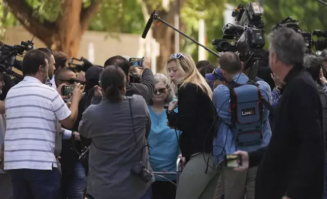 Family and supporters of Erik and Lyle Menendez are surrounded by media as they arrive at court for a hearing in the brothers' case Tuesday, May 13, 2025, in Los Angeles. (AP Photo/Damian Dovarganes)