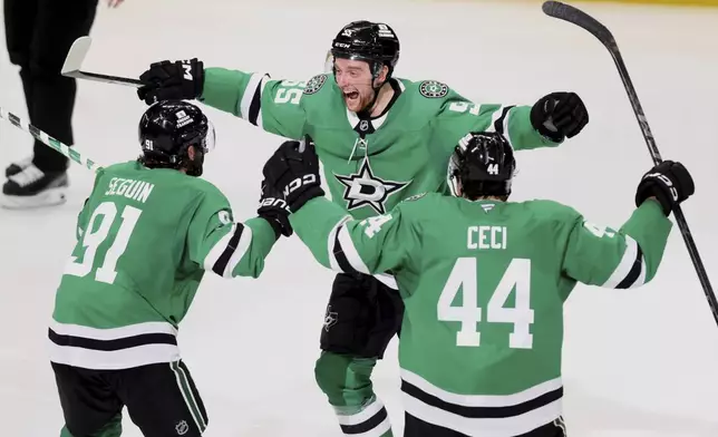 Dallas Stars' Tyler Seguin (91), Thomas Harley (55) and Cody Ceci (44) celebrate after Harley scored in overtime in Game 6 of a second-round NHL hockey playoff series against the Winnipeg Jets in Dallas, Saturday, May 17, 2025. (AP Photo/Gareth Patterson)