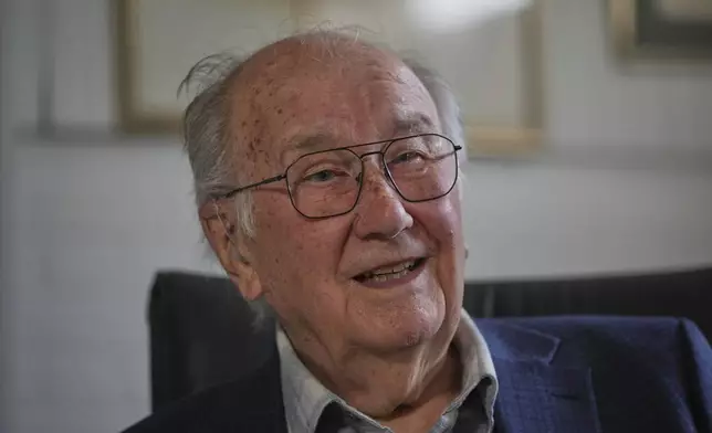 John Goldsmith, 94, draws during an interview at his home in London, Thursday, April 24, 2025. (AP Photo/Kin Cheung)