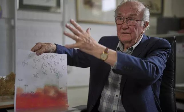 John Goldsmith, 94, shows his drawing during an interview at his home in London, Thursday, April 24, 2025. (AP Photo/Kin Cheung)