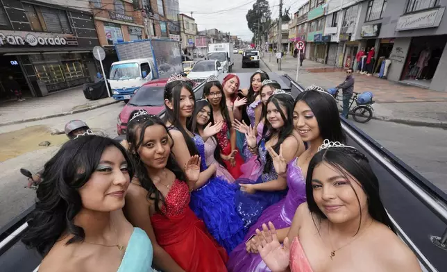 Quinceañeras ride in a limousine as part of their celebration, in Bogota, Colombia, Friday, May 2, 2025. The Sueños Hechos Foundation, led by a former police officer, is hosting a quinceañera celebration on Friday for 24 disadvantaged teen girls. (AP Photo/Fernando Vergara)