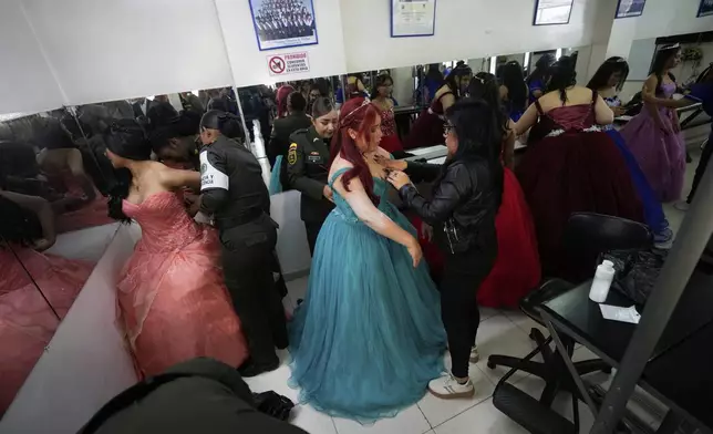 Quinceañeras ready for their celebration, in Bogota, Colombia, Friday, May 2, 2025. The Sueños Hechos Foundation, led by a former police officer, is hosting a quinceañera celebration on Friday for 24 disadvantaged teen girls. (AP Photo/Fernando Vergara)