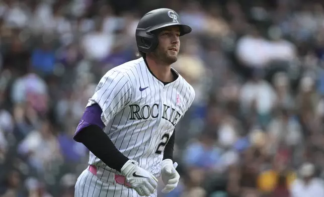 Colorado Rockies' Ryan McMahon runs the bases after hitting a one-run home run in the eighth inning of a baseball game against the San Diego Padres, Sunday, May 11, 2025, in Denver. (AP Photo/Geneva Heffernan)