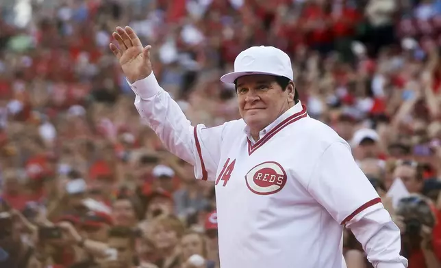 FILE - In this June 24, 2016, file photo, former Cincinnati Red Pete Rose waves to the crowd as he is introduced on the field during a ceremony to honor the 1976 World Series champions team, before the Reds' baseball game against the San Diego Padres in Cincinnati.  (AP Photo/John Minchillo, File)