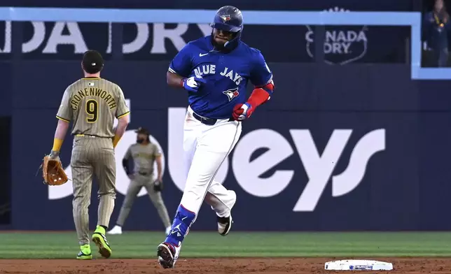 Toronto Blue Jays' Vladimir Guerrero Jr. (27) runs the bases after hitting a solo home run against the San Diego Padres during the first inning of a baseball game in Toronto on Tuesday, May 20, 2025. (Jon Blacker/The Canadian Press via AP)
