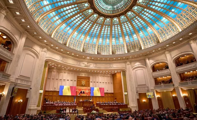 Romania’s newly elected president Nicusor Dan takes the oath as he is sworn in, at the parliament in Bucharest, Romania, Monday, May 26, 2025. (AP Photo/Vadim Ghirda)