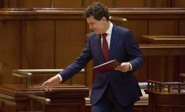 Romanian President Nicusor Dan smiles after taking the oath as the country's new president at the parliament in Bucharest, Romania, Monday, May 26, 2025. (AP Photo/Vadim Ghirda)