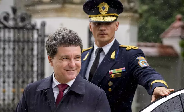 Romania's newly elected president Nicusor Dan arrives at the Cotroceni Presidential Palace to attend a welcoming ceremony, after being sworn in at the parliament, in Bucharest, Romania, Monday, May 26, 2025. (AP Photo/Andreea Alexandru)