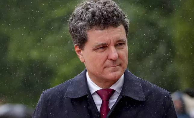 Romania's newly elected president Nicusor Dan reviews the honour guard during a welcoming ceremony at the Cotroceni Presidential Palace, after being sworn in at the parliament, in Bucharest, Romania, Monday, May 26, 2025. (AP Photo/Andreea Alexandru)