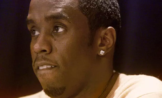 FILE - Rapper-producer Sean "Puffy" Combs answers questions at a news conference on Dec. 28, 1999, in New York, a day after he was arrested and charged with weapons possession after police allegedly found a stolen pistol in his car as he and actress-singer Jennifer Lopez left a nightclub where three people were shot and wounded. (AP Photo/Suzanne Plunkett, File)