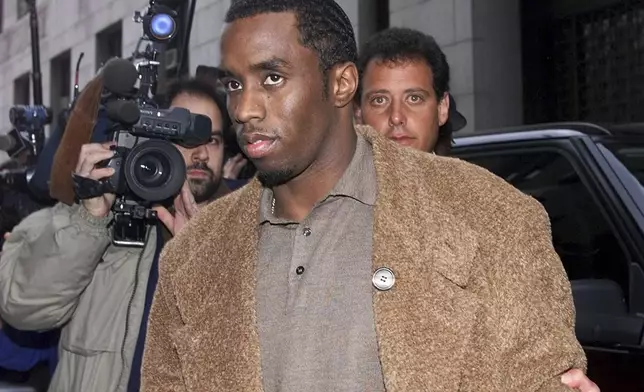 FILE - Rapper Sean "Puffy" Combs arrives at the Manhattan District Attorney's office in New York, on Jan. 4, 2000, where Combs and his girlfriend Jennifer Lopez were to appear before a grand jury investigating the Times Square nightclub shooting that left three people injured in late Dec. 1999. (AP Photo/Kathy Willens, File)