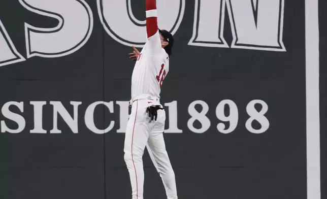 Boston Red Sox outfielder Jarren Duran (16) leaps and makes the catch on a fly out by New York Mets' Francisco Lindor during the fifth inning of a baseball game at Fenway Park, Wednesday, May 21, 2025, in Boston. (AP Photo/Charles Krupa)