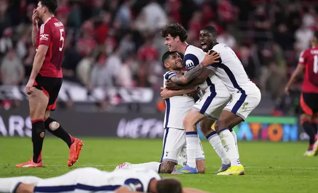 Tottenham players, from right, Kevin Danso, Archie Gray, and Cristian Romero celebrate after winning the Europa League final soccer match against Manchester United at the San Mames Stadium in Bilbao, Spain, Wednesday, May 21, 2025. (AP Photo/Manu Fernandez)
