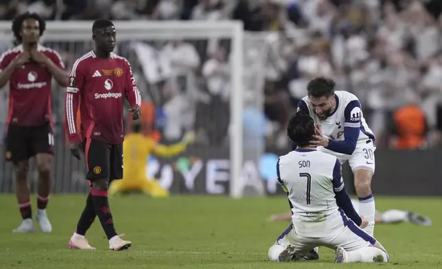 Tottenham's Son Heung-min and Tottenham's Rodrigo Bentancur celebrate at the end of the Europa League final soccer match between Tottenham Hotspur and Manchester United at the San Mames Stadium in Bilbao, Spain, Wednesday, May 21, 2025. (AP Photo/Bernat Armangue)