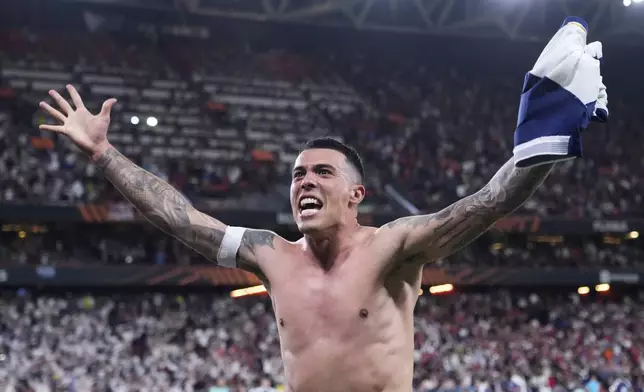 Tottenham's Pedro Porro celebrates after winning the Europa League final soccer match against Manchester United at the San Mames Stadium in Bilbao, Spain, Wednesday, May 21, 2025. (AP Photo/Jose Breton)