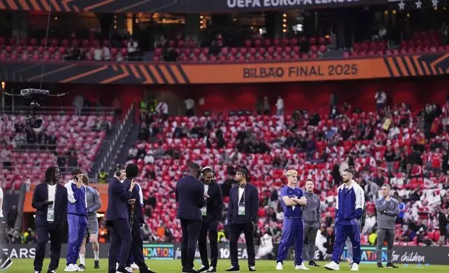 Tottenham players walk on the pitch ahead of the Europa League final soccer match between Tottenham Hotspur and Manchester United at the San Mames Stadium in Bilbao, Spain, Wednesday, May 21, 2025. (AP Photo/Jose Breton)