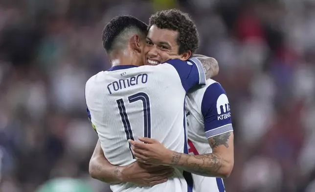 Tottenham's Brennan Johnson, right, celebrates with Tottenham's Cristian Romero after scoring his side's opening goal during the Europa League final soccer match between Tottenham Hotspur and Manchester United at the San Mames Stadium in Bilbao, Spain, Wednesday, May 21, 2025. (AP Photo/Jose Breton)