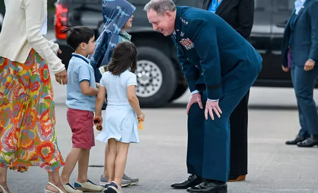 U.S. Air Force General James Hecker leans down to talk with U.S. Vice President JD Vance's children prior to Vance and his family departing Ramstein Air Base, Germany, Thursday April 24, 2025. (Kenny Holston/Pool Photo via AP)