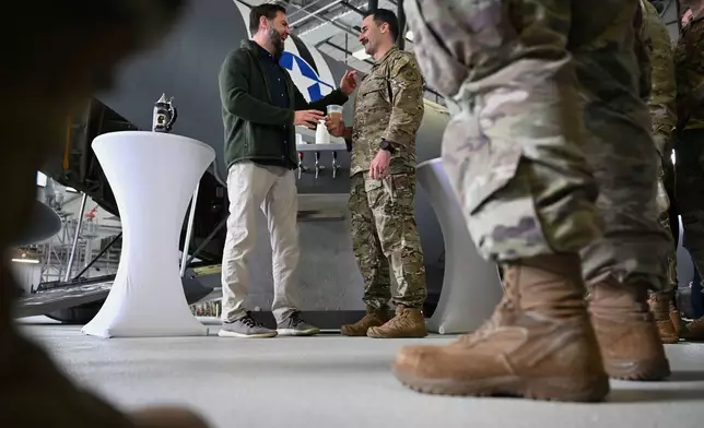 U.S. Vice President JD Vance gives a toast to U.S. service members during a refueling stop at Ramstein Air Base, Germany, Thursday, April 24, 2025. (Kenny Holston/The New York Times via AP, Pool)